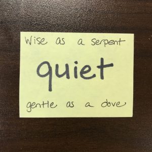 sticky note on desk that reads "quiet: wise as a serpent, gentle as a dove"